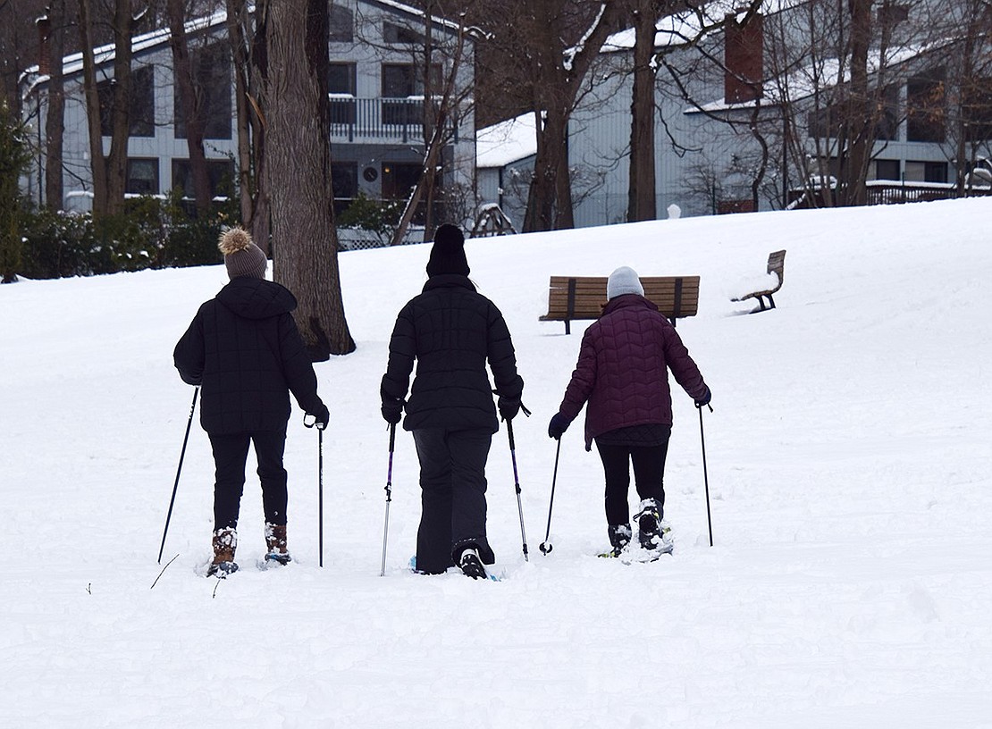 Three women take the opportunity to break out their snowshoes and make their way across the midsection of Crawford Park.