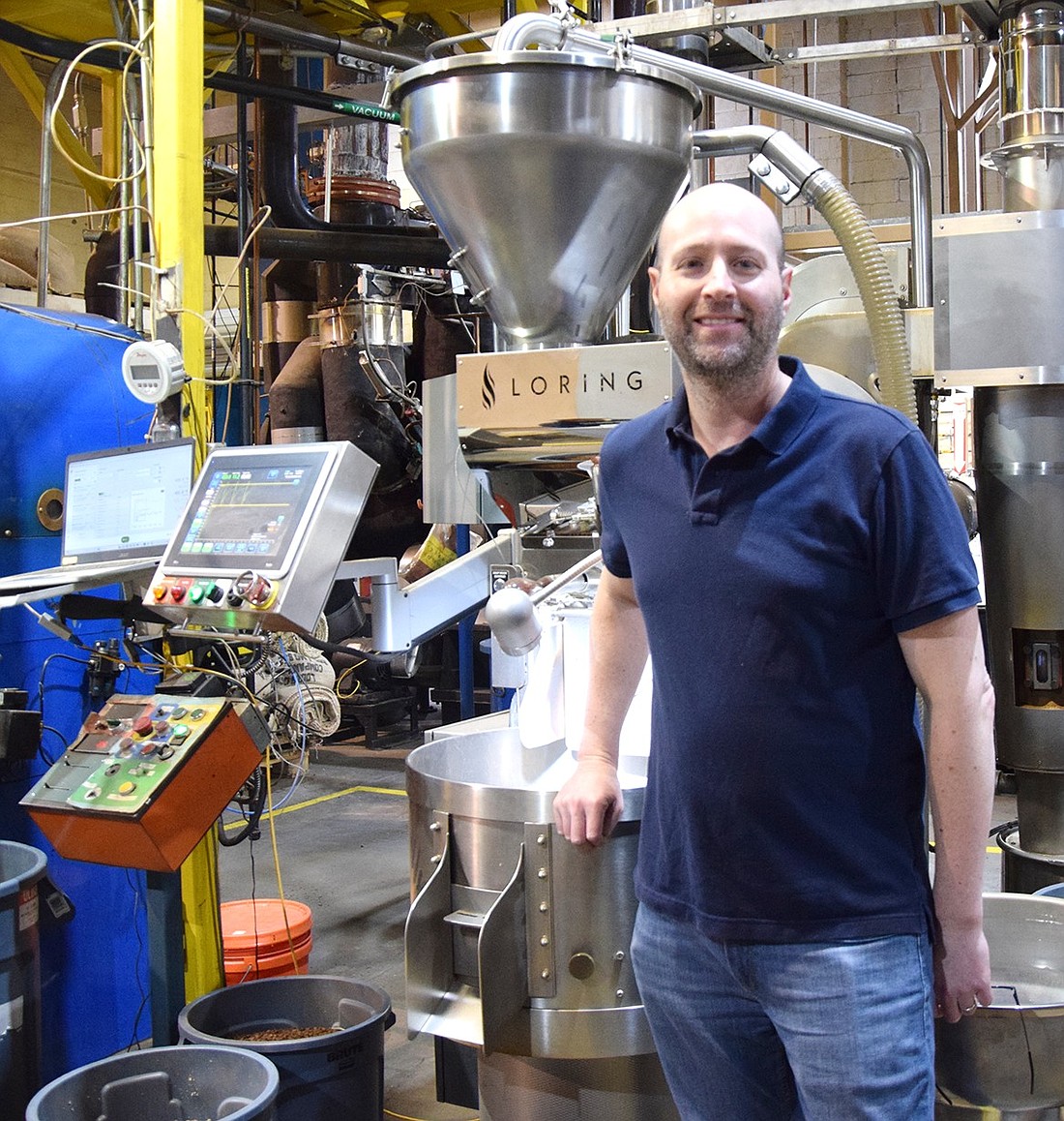 Rye Brook resident Jason Richter poses next to a Loring S15 coffee roaster, which heats all of Path Coffee Roasters’ beans. In an effort to spread the popularity of high-end, specialty coffee to Westchester, Richter founded the company in 2012, delivering products from 106 Purdy Ave.