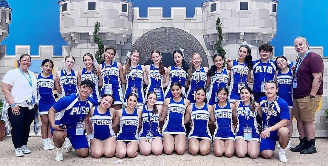 The Port Chester High School varsity cheerleaders pose with their coaches at the United Cheerleading Association National High School Cheerleading Championship at Disney World in Orlando, Fla.