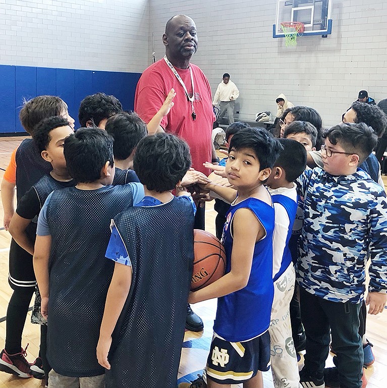 Derek Vincent works with young basketball players who will participate in March Madness at Carver Center starting Saturday, Mar. 2 and running every Saturday through Mar. 23.