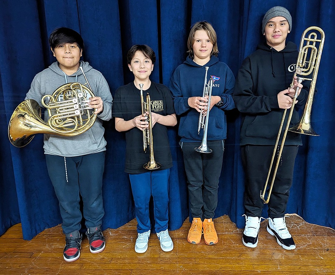 Port Chester Middle School seventh-grade French hornist Angel Gonzales (left), seventh-grade trumpeter Alan Grande, eighth-grade trumpeter Adam Van Der Wateren and seventh-grade trombonist Aiden Escobar pose for a photo with their instruments. The quartet will be performing as part of the Westchester Chamber Music Society’s youth initiative on Sunday, Mar. 10, playing brief selections of works in front of professional musicians at Congregation Emanu-El of Westchester in Rye at 2125 Westchester Ave.