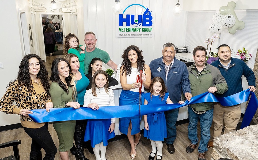 CEO Courtney Bellew cuts the ribbon at the grand opening of HUB Veterinary Group at 316 Boston Post Rd. on Thursday, Mar. 7. This spot was for many years the location of various restaurants, the last one being Il Sogno, but has been vacant for several years. Joining Bellew are, from left, Dr. Nicole Peta (lead veterinarian), Lauren Ferrara (Operations), Tabitha Landow (practice manager), Alizé Carter (technician), Hudson Bellew, Parker Bellew, Port Chester Mayor Luis Marino, Port Chester Trustee Phil Dorazio and Dan Alvarez from the Port Chester-Rye Brook-Rye Town Chamber of Commerce. In the back is owner Timothy Bellew holding the Bellews’ youngest daughter, Mason.