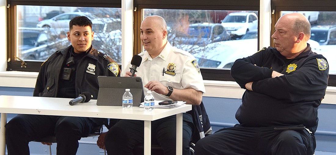 Port Chester Police Chief Chistopher Rosabella (with microphone) answers a question posed by a community member during a public information event at the Carver Center on Thursday, Mar. 21. Officer Chris Bernal (left) and Captain Charles Nielsen flank him. The event, co-sponsored by Port Chester Immigrant Defense and the Carver Center, aimed to provide Hispanic immigrants with a way to meet and connect with the Village police force.