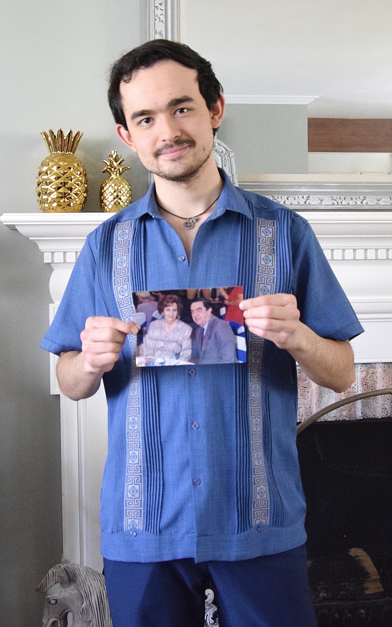 Rye Brook resident Guillermo Prieto IV, a senior film student at NYU Tisch School of the Arts, poses with a photo of his paternal grandparents. They’re the subject of the short film he’s submitting as his senior thesis, titled “El Pumita.” With aspirations to film across New York State, including Rye Brook, he’s currently raising funds to finance the project.