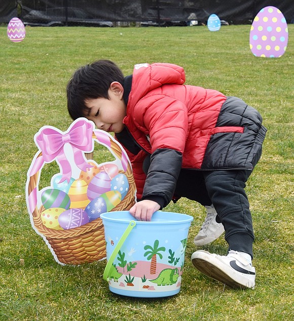 Making sure no egg is unturned, 5-year-old Miles Chu of Winthrop Drive peeks behind a decorative cutout for any missed treats.