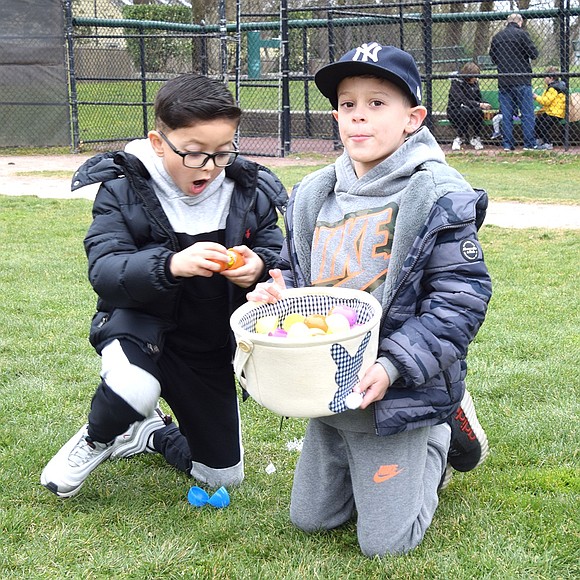 Port Chester resident Nino Bellomusto (left), 5, expressively shows his excitement after opening one of the Easter eggs he’s gathered with 6-year-old Grayson Cabezas, also of Port Chester.