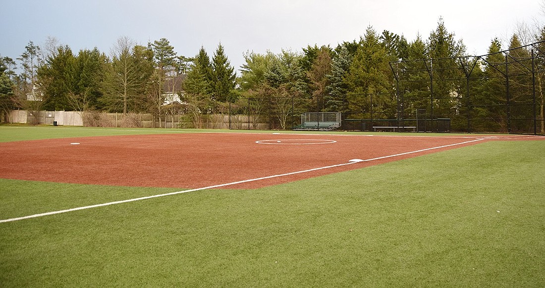 The synthetic turf baseball diamond in the Rye Brook Athletic Fields complex sits clean after a rain shower on Wednesday, Mar. 27. It’s one of the 14 sports facilities found across Port Chester and Rye Brook. Each municipality maintains its own fields, and representatives from each local government have different ideas as to whether artificial or natural grass suits their community needs best.
