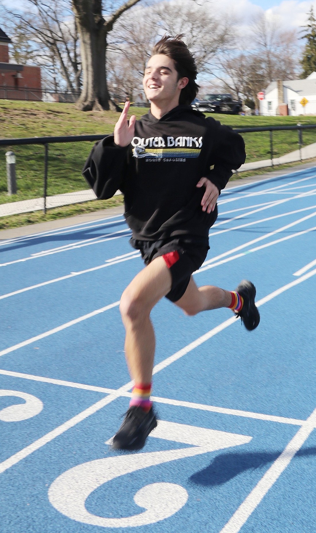 Sprinter Nicholas Wolff enjoys the beautiful weather during track practice on Monday, Mar. 18.