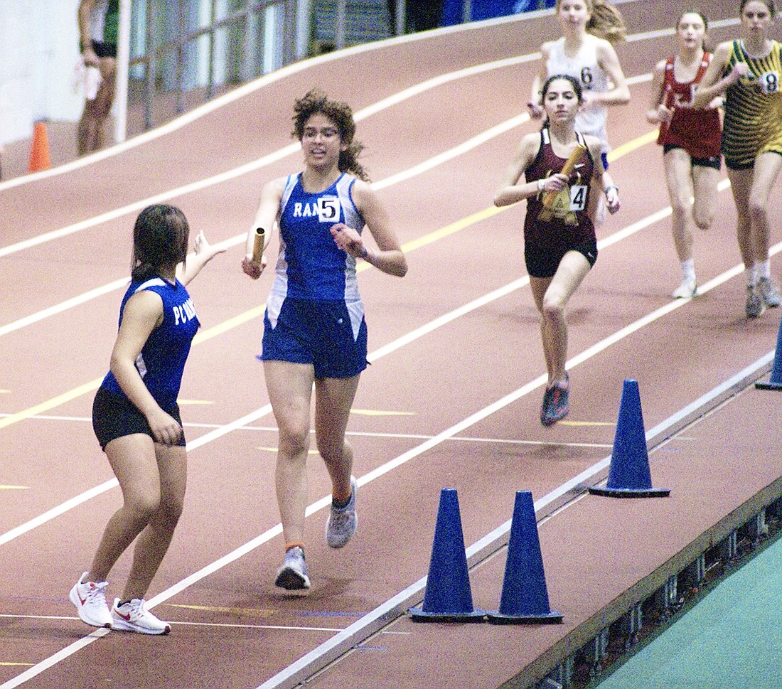 Juliana Castillo passes the baton to Casey Schultz at The Armory in New York City during the Class AA Championships on Feb. 12 during the indoor track season. New head track coach Greg Domestico is teaching his Ram and Lady Ram relay runners a more efficient way to hand off the baton in preparation for the upcoming Pearl River Relays on Apr. 6 and Penn Relays at the University of Pennsylvania Apr. 25-27.