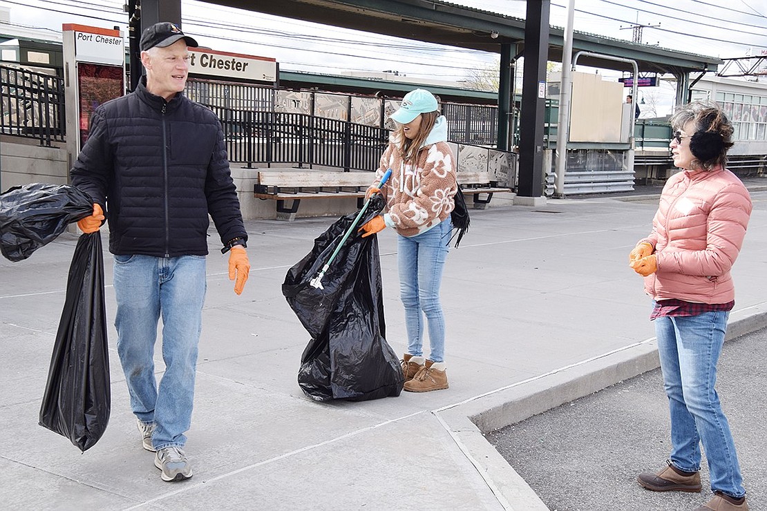 Robert and Kathy Schick of White Plains and Joanne Mennona of the Bronx pick up litter at the Port Chester Metro-North station. They are members of The Capitol Theatre’s Cap Cares group.