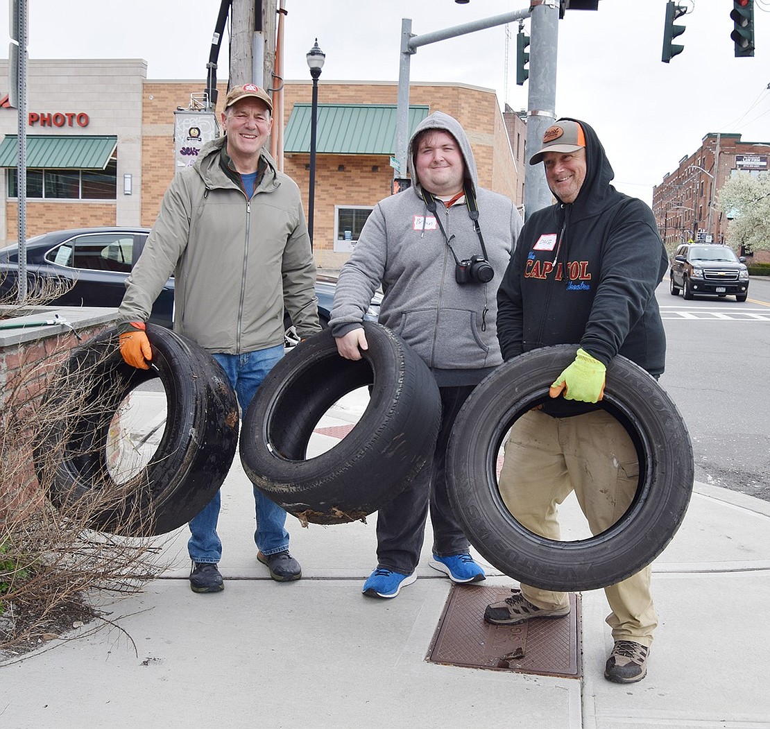 Mike McLaughlin of Betsy Brown Circle, Brian Sullivan of Webster Place, a member of the Port Chester Beautification Committee, and Dave Engleman of The Capitol Theatre Street Team and Port Chester Entertainment Committee each hold tires they pulled out of hidden spaces in downtown Port Chester while participating in the Community Cleanup and Planting Day involving Port Chester, Rye Town, Rye Neck and Rye City on Saturday, Apr. 13. Rye Brook’s event was postponed due to plants not arriving in time.