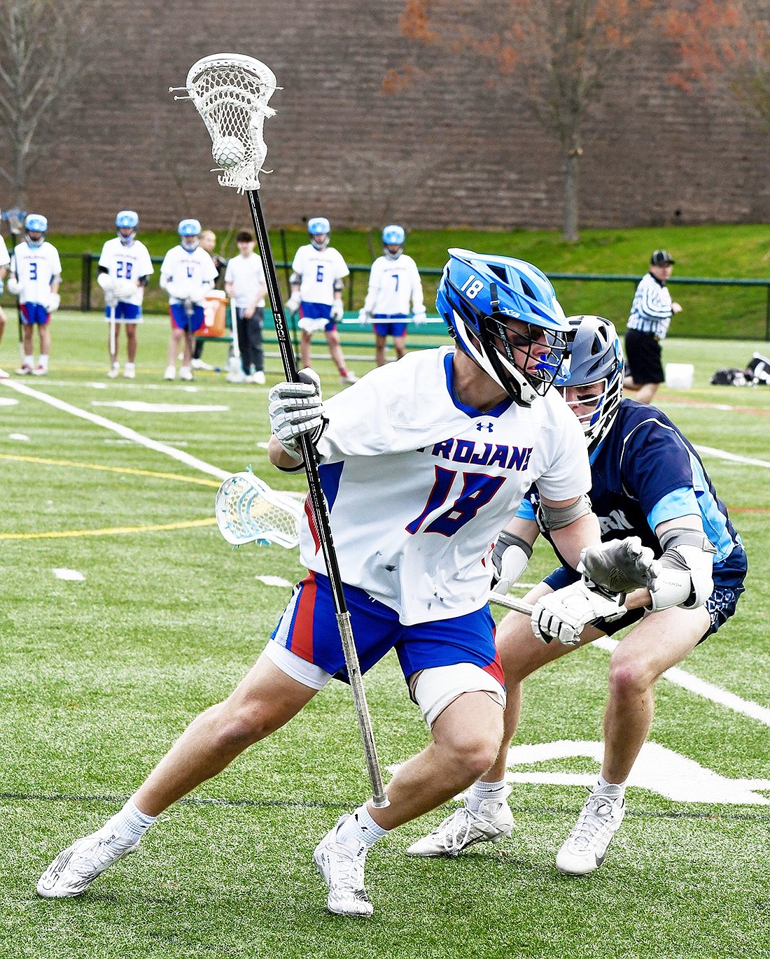 Senior captain and Muhlenberg lacrosse commit Seth Low maneuvers around Suffern to pass the ball during the Trojans’ Friday, Apr. 19 home win over the Mounties.