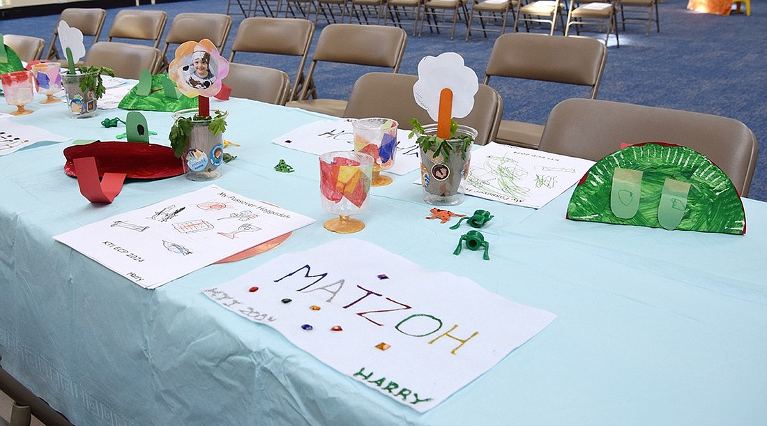 A table in the Congregation KTI synagogue sits with decorations created by children to practice a Passover seder on Wednesday, Apr. 18. Children learning the Passover story is an important part of the holiday, and with the ongoing war abroad, Rabbi Ben Goldberg believes it’s even more relevant this year.