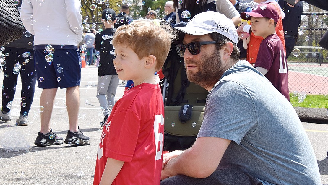 Three-year-old Rye Brook resident Bennett Hochhauser stands back with his dad Lance, choosing to enjoy the bubbles at Pine Ridge Park from a distance.