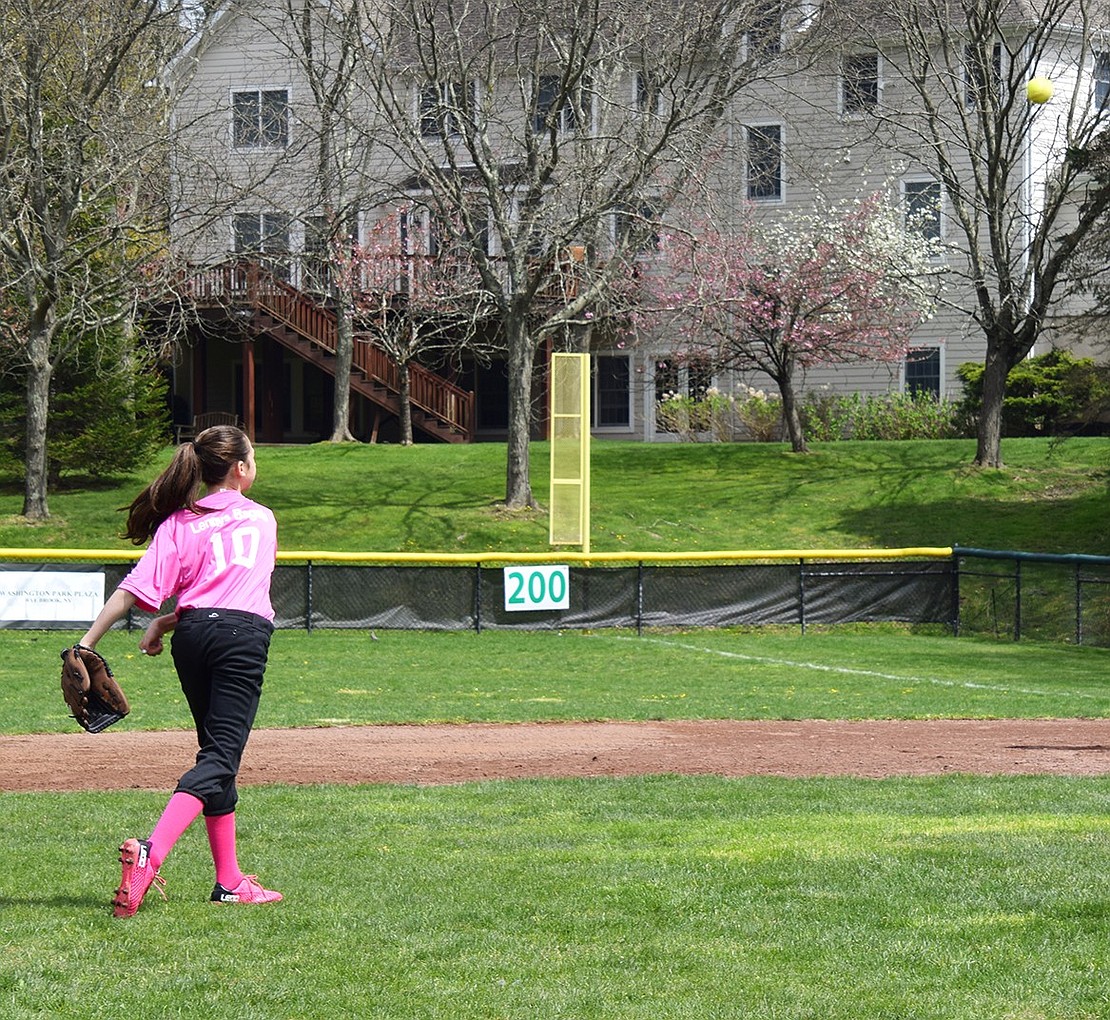 Ridge Street Elementary School fifth-grader Sophia Goldman gets some reps in before the start of her first Little League softball game of the year.