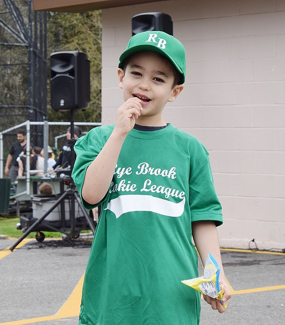 Ridge Street Elementary School kindergartener Alexander Tecsila enjoys some candy after the walk to the park.