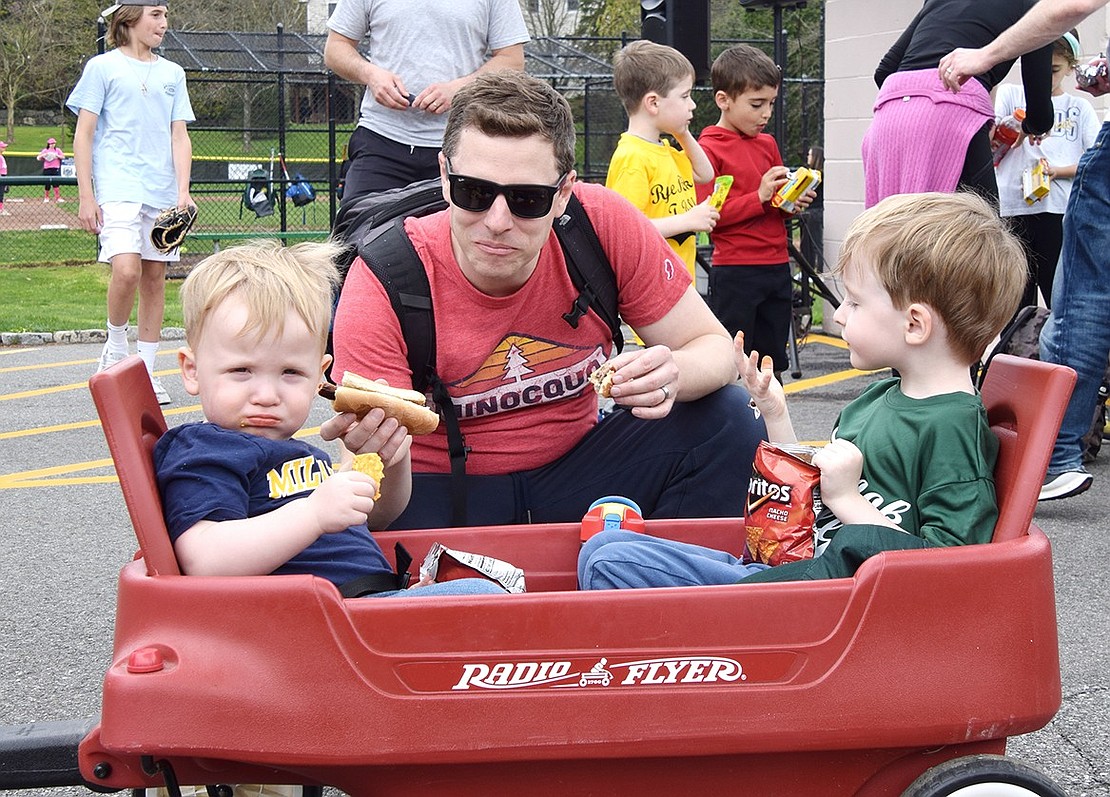 Elm Hill Drive dad David Krahn kneels down to have a snack with his sons, 1-year-old Noah (left) and 5-year-old Henry.