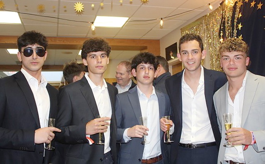 From left, Eduardo Almeida-Jarufe, Ryan Stiler, Evan Levitan, Ian Sherman and Robby Carey pose for the camera, sparkling apple cider in hand, on the red carpet before the Honors Shapers of the World Night at the Oscars ceremony on Friday, Apr. 26 at Blind Brook High School.