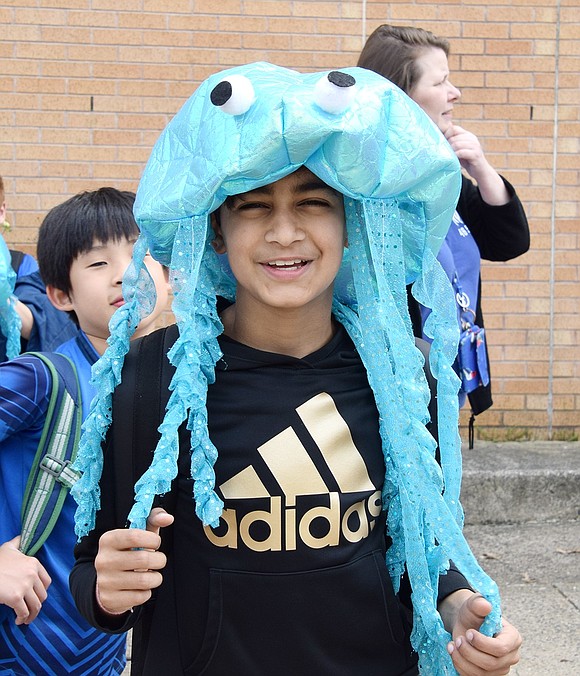 Aayush Rawal, a fourth-grader at Ridge Street School, poses wearing a club member’s iconic turquoise jellyfish hat outside of Blind Brook High School prior to the start of the session.