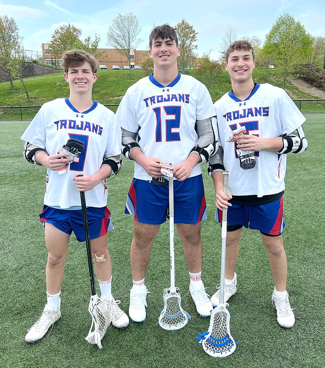 Blind Brook High School varsity lacrosse players Chase Katz (left), Tyler Taerstein, both sophomores, and Zach Taerstein, a junior, pose for a photo while wearing the socks used to promote their Lacrosse the Nations fundraiser before a game against Hastings High School on Apr. 30. Together, they’ve raised $2,400 for scholastic scholarships and school supplies for students in Nicaragua.