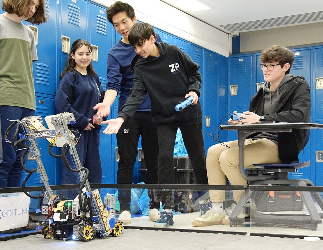 Members of the Blind Brook High School robotics club team, the Jellyfish, assist Blind Brook Middle School eighth-grader Nirvaan Bhura as he test drives their competitive bot Michele on Thursday, May 16. They’re participating in CreatiCon, an annual showcase for students across the district to show off their creative works that returned last week after a five-year hiatus.