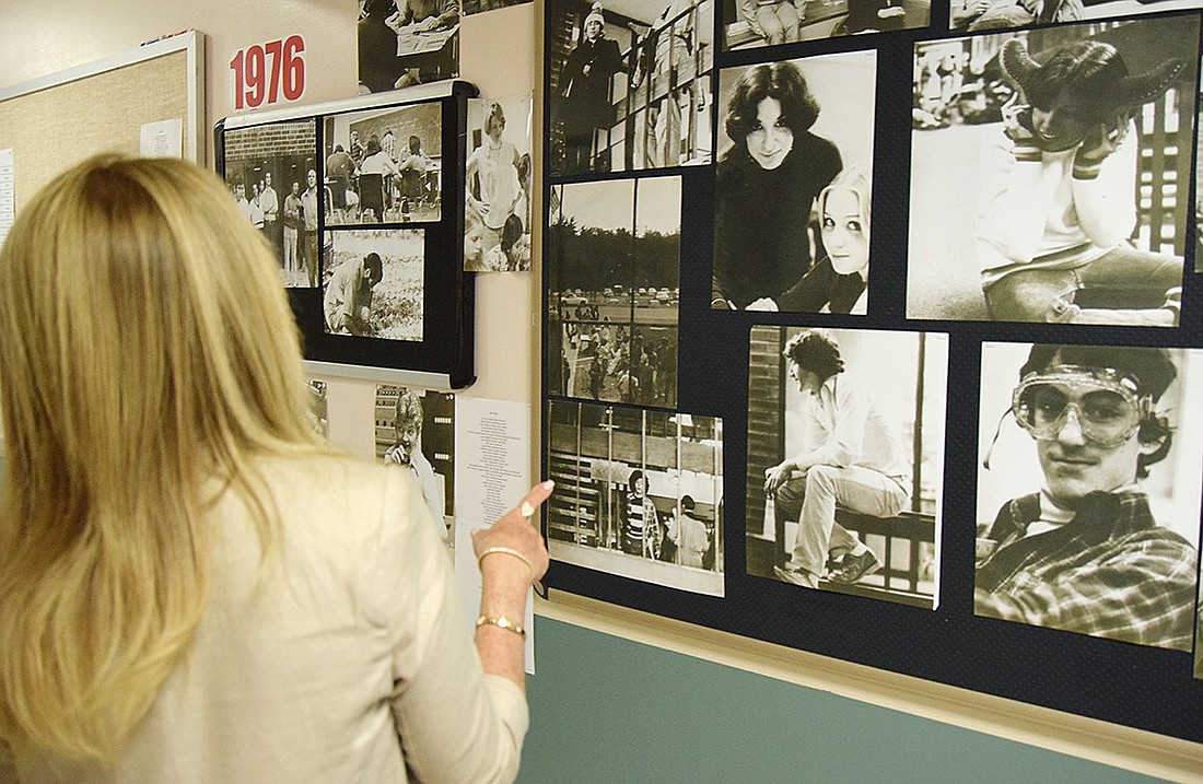 Stacey Kaufman, a Blind Brook High School Class of 1980 alum, goes through old photos plastered on the hallway walls to look for images of her and her husband Larry. The high school sweethearts and Rye Brook residents were visiting their old stomping grounds to celebrate the anniversary.