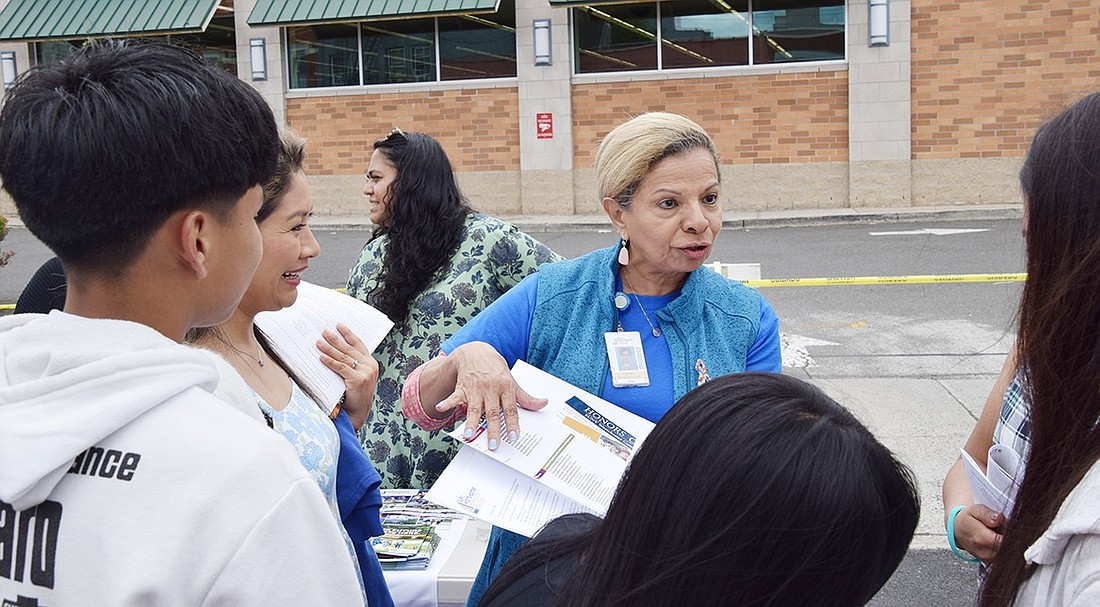 Dr. Carmen Martinez-Lopez, the Westchester Community College dean of the School of Business, speaks with parents about how the institution can accommodate the language and financial needs of all students during a resource fair on Sunday, May 19. The event, hosted by the Port Chester Hispanic Advisory Board, shut down a section of Adee Street to help educate Spanish-speaking residents on what resources are available to them at the local, county and state level.