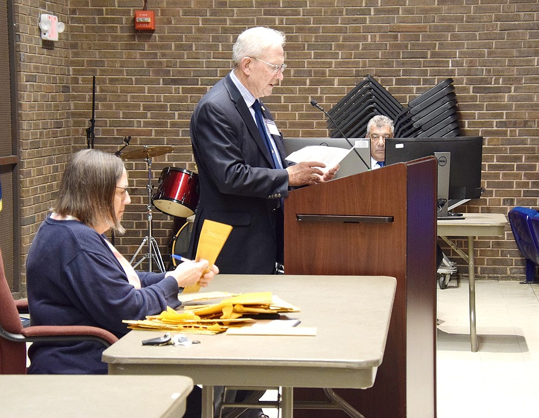 Port Chester District Clerk Cathy Maggi unpackages absentee ballots to pass to election chairman Michael O’Connor to announce on election night on Tuesday, May 21. In the back, Assistant Superintendent for Business Philp Silano records the tallies.