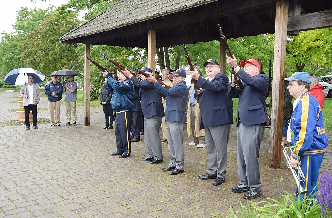 Members of the Port Chester American Legion Firing Team fire a 3-shot volley to honor all veterans who died at sea at the Port Chester Marina on Abendroth Avenue during the first of nine brief services of remembrance at the various memorials throughout the Village of Port Chester and in Crawford Park to recognize Memorial Day.