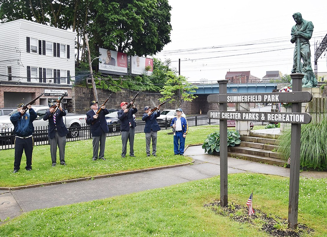 Members of the Port Chester American Legion Firing Team fire a 3-shot volley to honor all deceased veterans of the Spanish American War at the Spanish American War memorial in Summerfield Park.