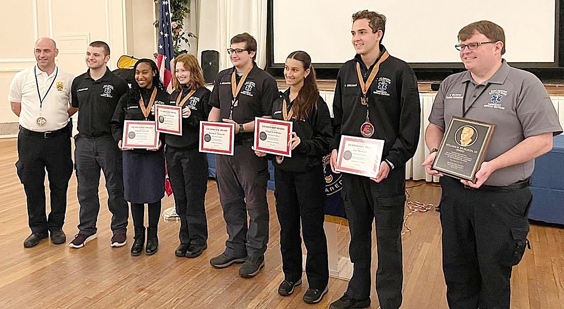 Port Chester-Rye-Rye Brook Emergency Medical Services (EMS) Administrator Kenny Barton (left) stands with Explorer Post 77 member Daniel Pellegrini to support the local Post 77 winners of the Exploring Leadership Award Abby Garrick, Laurel Lowenthal, Matthew Pellegrini, Abby Goldstein, Ian Sherman and Post Advisor Michael Wellington on May 16. The five local teens were nominated for the Greater Hudson Valley Council achievement by their EMS peers.