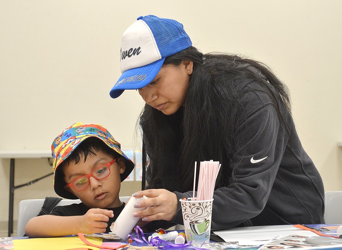 Alison Barreto of Poningo Street helps her 3-year-old son Owen Lalvay make a craft project at the Port Chester-Rye Brook Public Library as part of the second annual Port Chester Arts Festival for all ages throughout Port Chester and Rye Brook on Saturday, June 1. See additional photos on page 20.