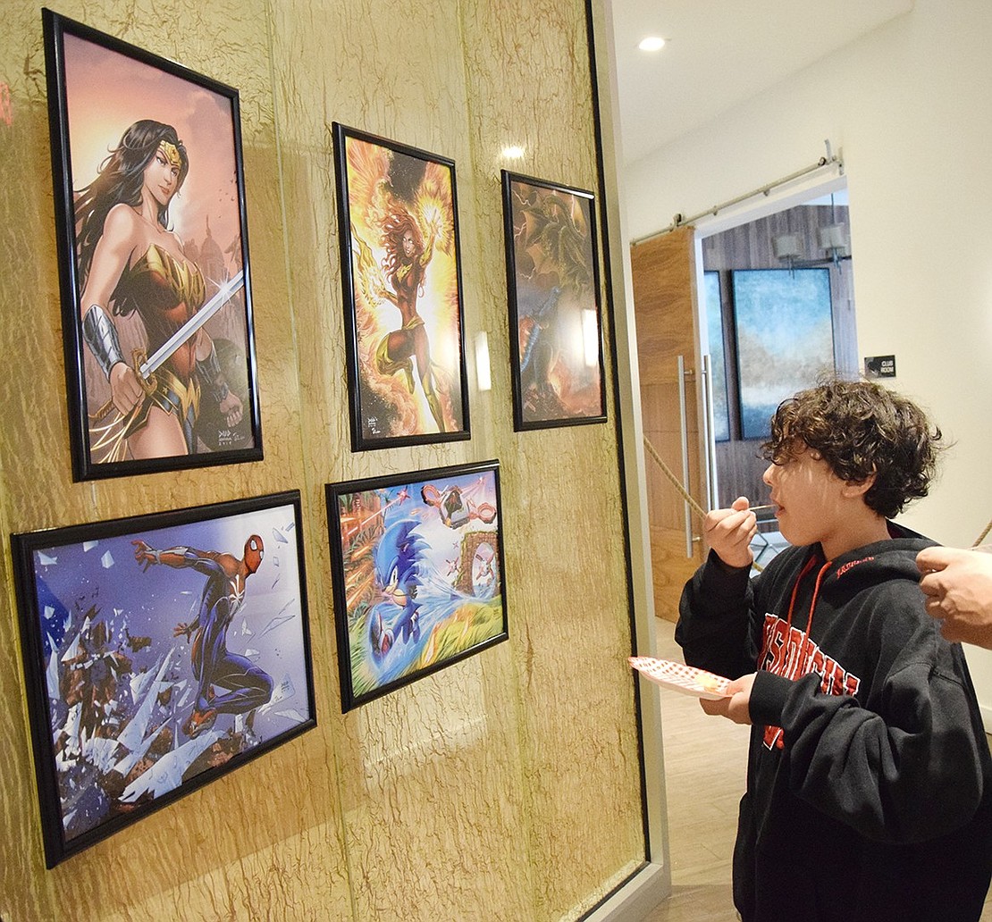 Nine-year-old Alex Calman admires the pop culture-inspired art in the lobby of The Castle, the 201 Willett Ave. building he lives in. It was just one of many locations throughout Port Chester and Rye Brook where art of all varieties was displayed, practiced and performed during the Port Chester Arts Festival on Saturday, June 1.