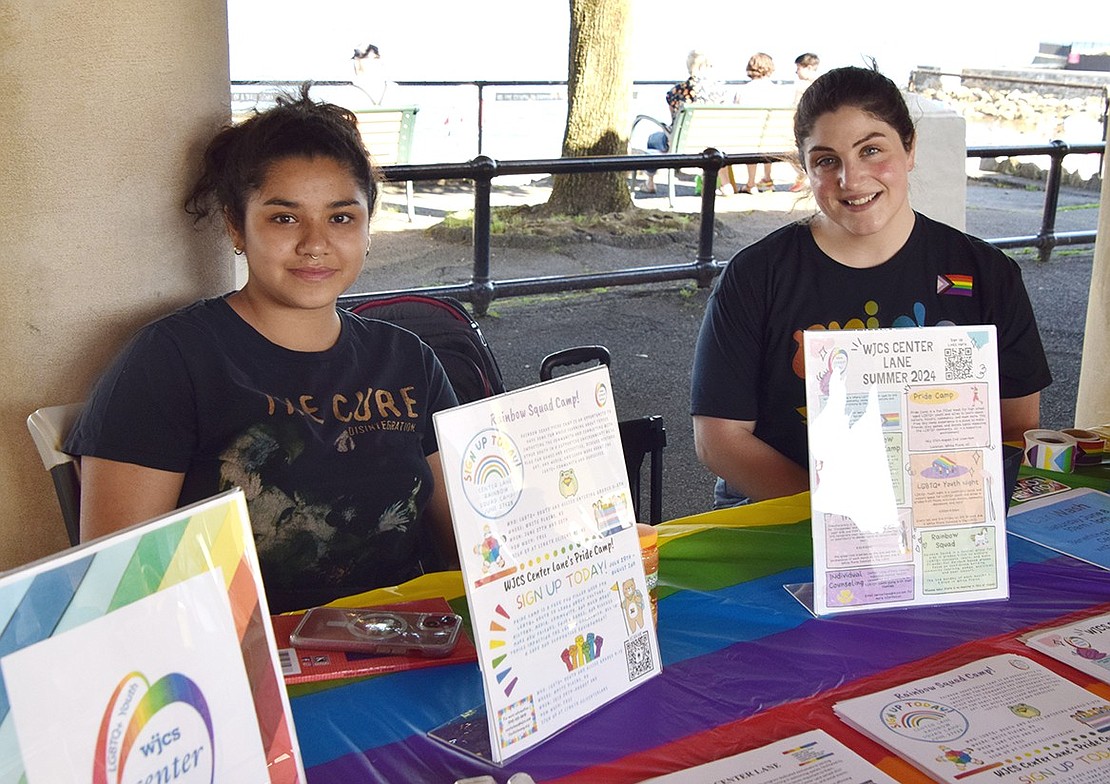 Bloomfield, N.J., resident Arianna Erraez (left), an intern with the Westchester Jewish Community Services’ Center Lane for LGBTQ Youth, and Elizabeth Verrastro, a social worker from Port Chester, smile at their table.