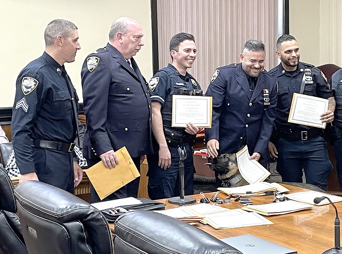 Port Chester Police Association President Mike Giandurco (left) stands with Captain Charles Nielsen, Officer Moises Ochoa, Officer Marcelo Pereira, Officer David Arroyo and K9 Mac (below) after honoring them with an Excellent Police Duty Award at a Board of Trustees meeting on May 20. The union gave out over 20 awards that night to honor excellence in local law enforcement.