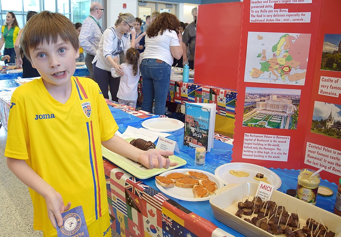 Ridge Street School fourth-grader Alex Mihes highlights some facts he’s collected about Romania at the school’s first Multicultural Festival on Friday, June 7. Funded by the PTA, the event brought families to the cafetorium to celebrate the various ethnic backgrounds seen in the community.