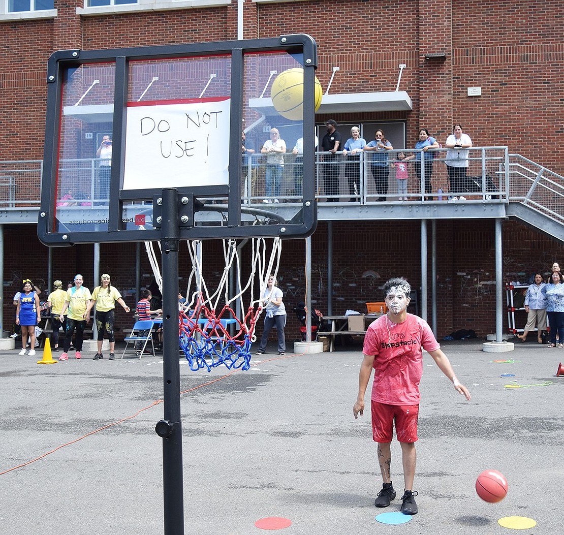 Teacher’s aide David Estevez tries to score a basket to advance to the next stage of the course.