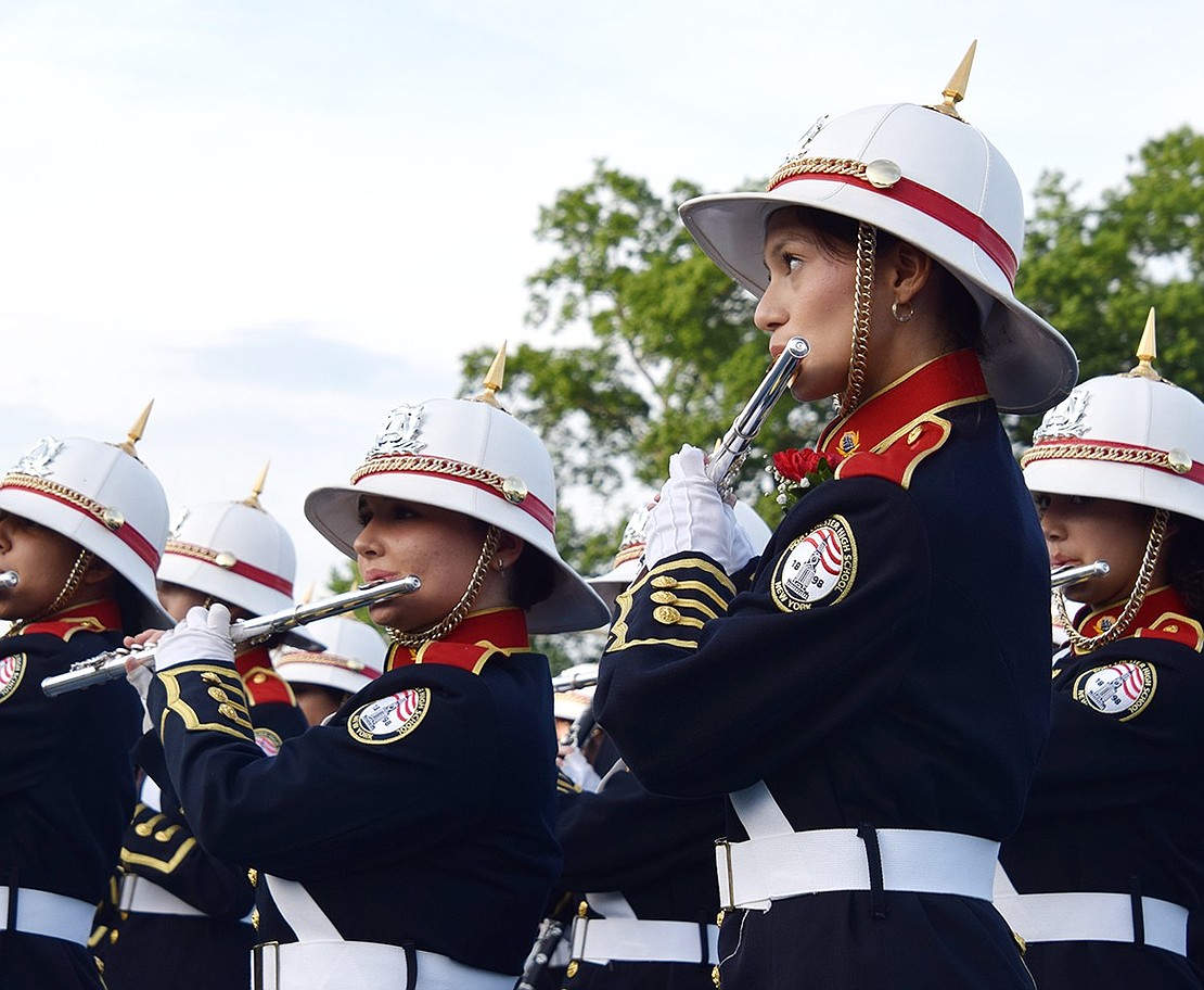 Band Night kicks off with the Port Chester High School marching band, including senior flutist Alexandra Cruz (right), playing the national anthem.