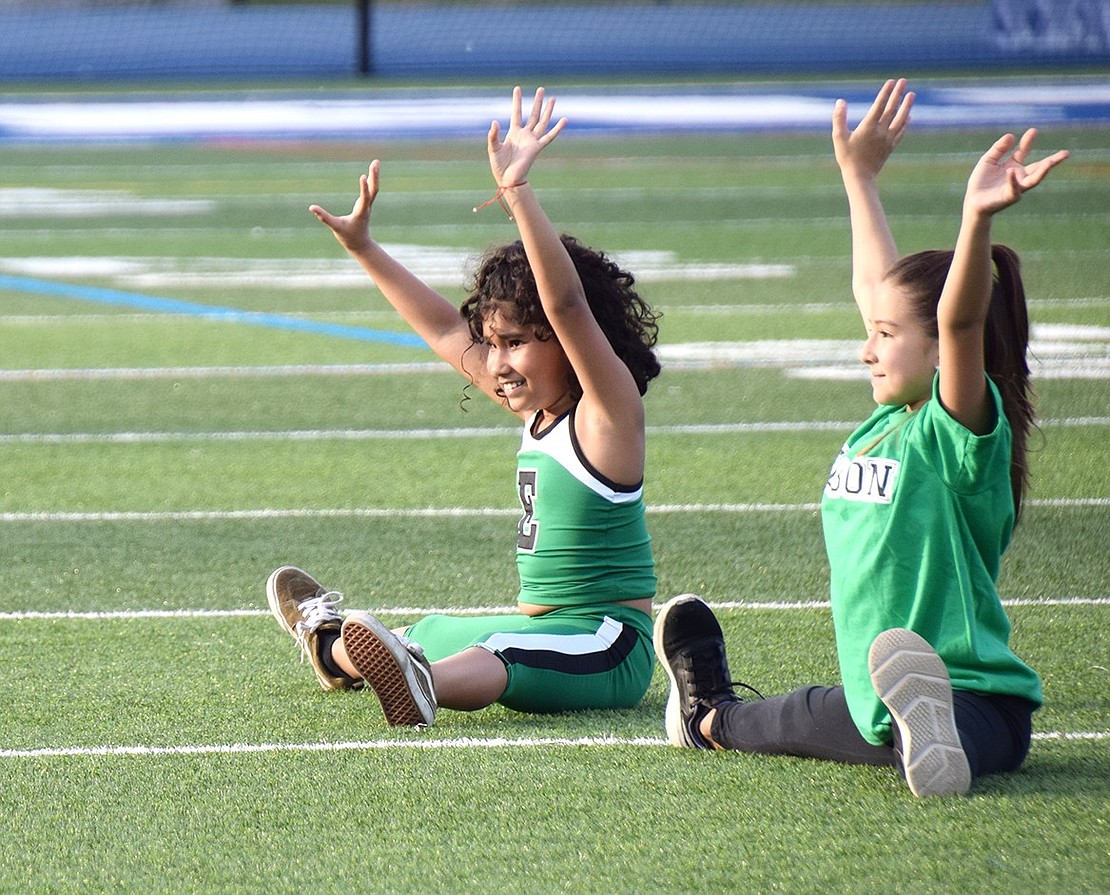 With a quick feature to demonstrate their acrobatic skills, Edison School fourth-grader Eliana Bonilla (left) and third-grader Sarah Alcedo make a graceful landing after doing some cartwheels.