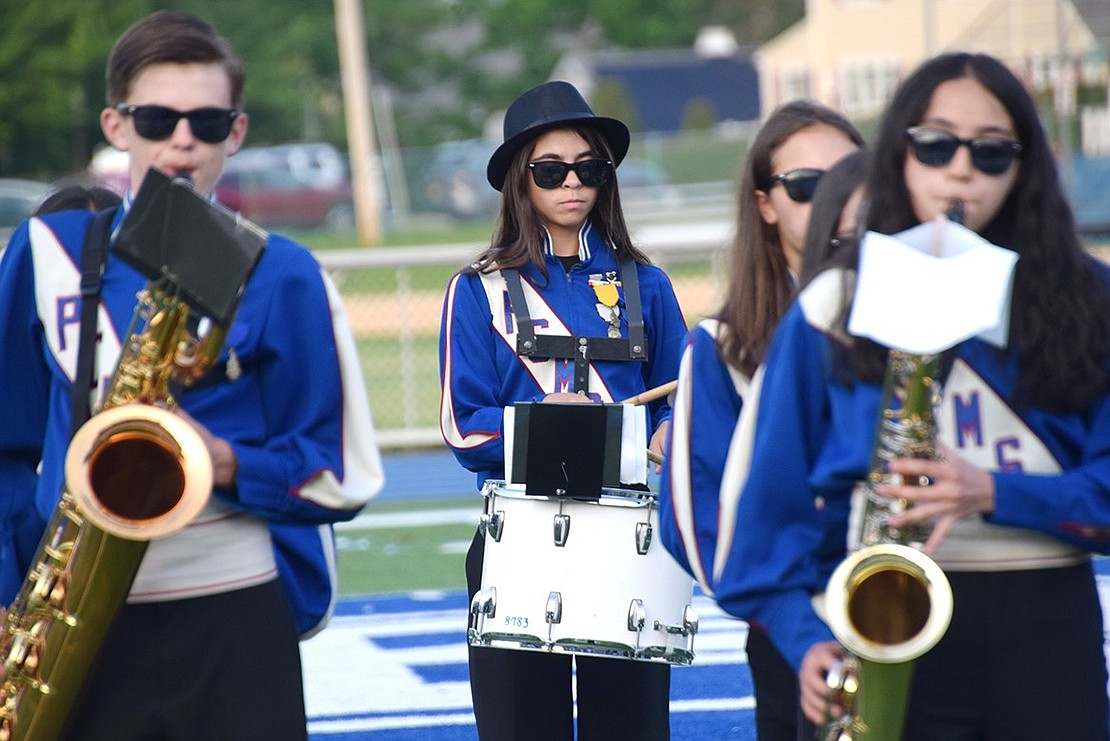 Wearing sunglasses to keep in theme with the eighth-grade band’s “The Blues Brothers” repertoire, Sophia Faraci keeps the beat on the snare drum behind a few saxophonists. In the front are George Ford (left) and Cielo Vintimilla.