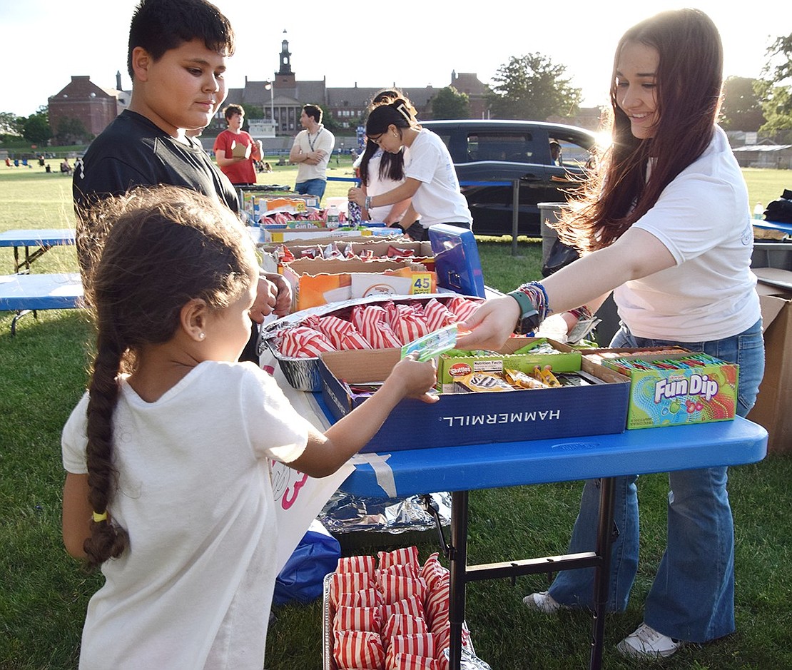 King Street resident Elvis Gonzales, Jr. tags along with his younger sister Ava as she grabs a snack from Port Chester High School sophomore Scarlett Pimento.