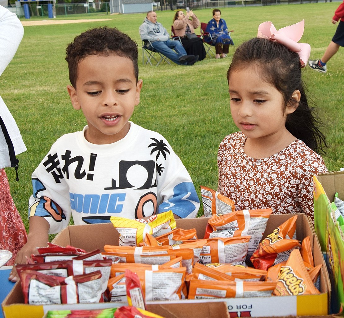 JFK kindergarteners Sebastian Fernandez (left) and Elizabeth Aguilar consider what salty treat they’ll snack on during the movie.