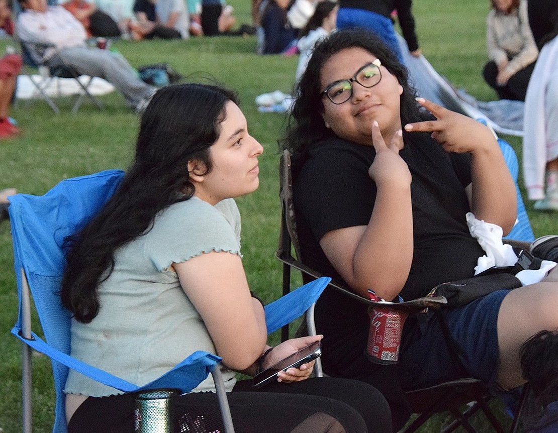 Port Chester High School sophomore Jaccellys Marquez (left) intently watches the previews for the movie while her classmate Alejandro Mojica poses, having spotted the camera.