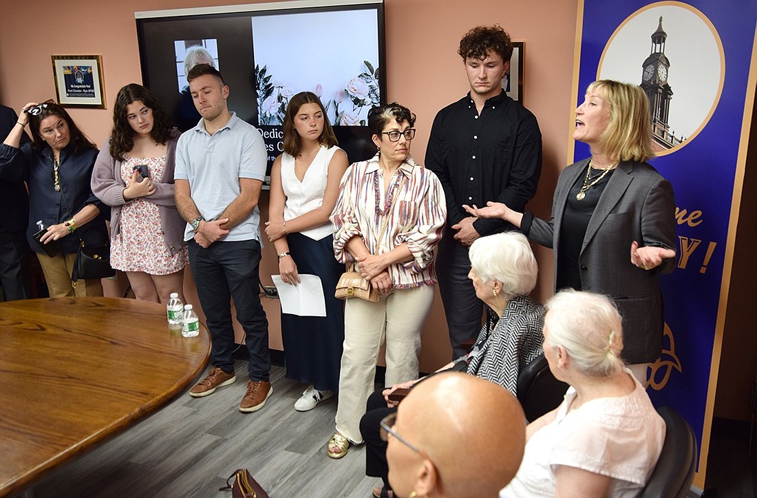 Claire Capeci Sucre (right) speaks to a crowd of around 30 people gathered in the Port Chester School District Board Room on Wednesday, June 12. The space has been revamped and dedicated to her late mother, Anne Capeci, a known figure around town who served on the school board for 30 years.