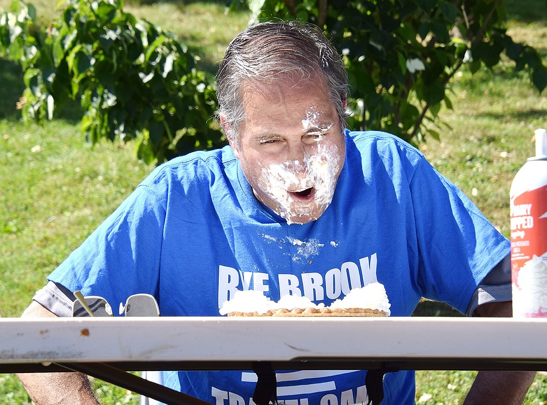 Rye Brook Trustee Sal Morlino comes up for air after diving his face into whipped cream during the pie eating contest, which has become a Village Birthday Party tradition.