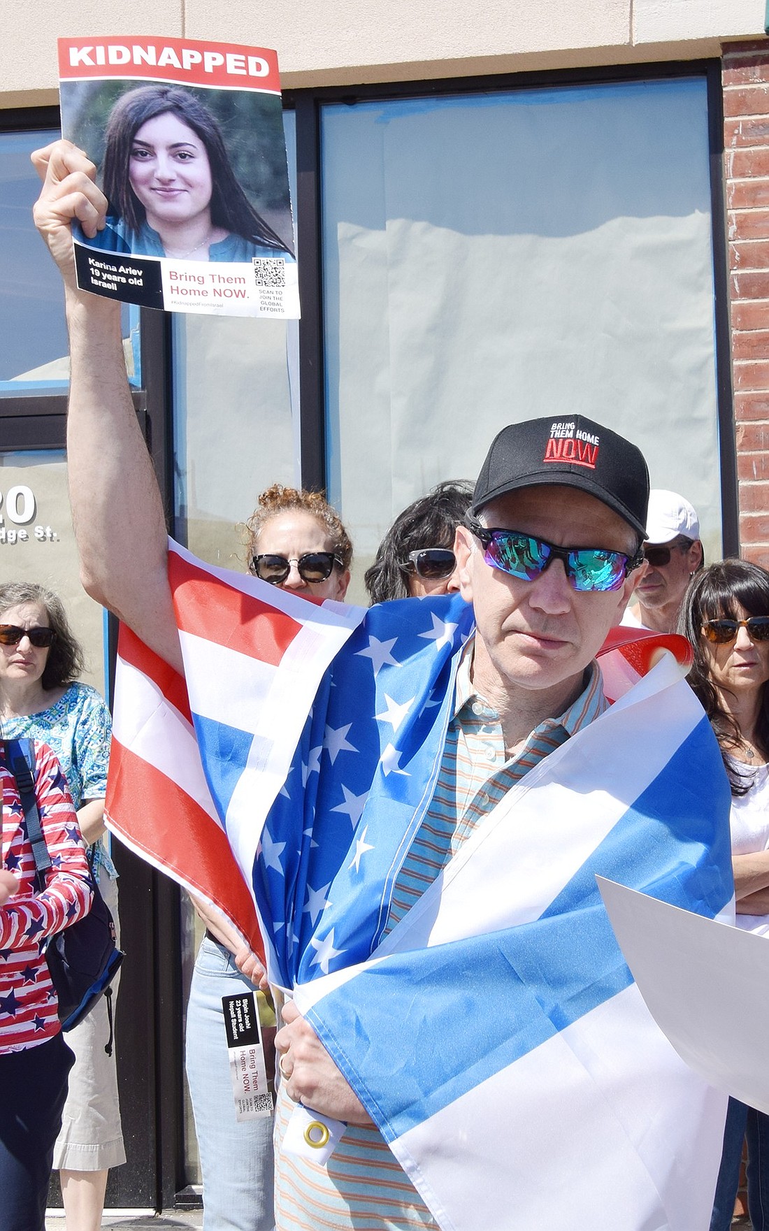 Rye Brook resident Steve Handler holds up a poster depicting one of the hostages taken during the Israel-Hamas war during the Walk for Their Lives march in solidarity of the victims at the Rye Ridge Shopping Center on Sunday, June 16.