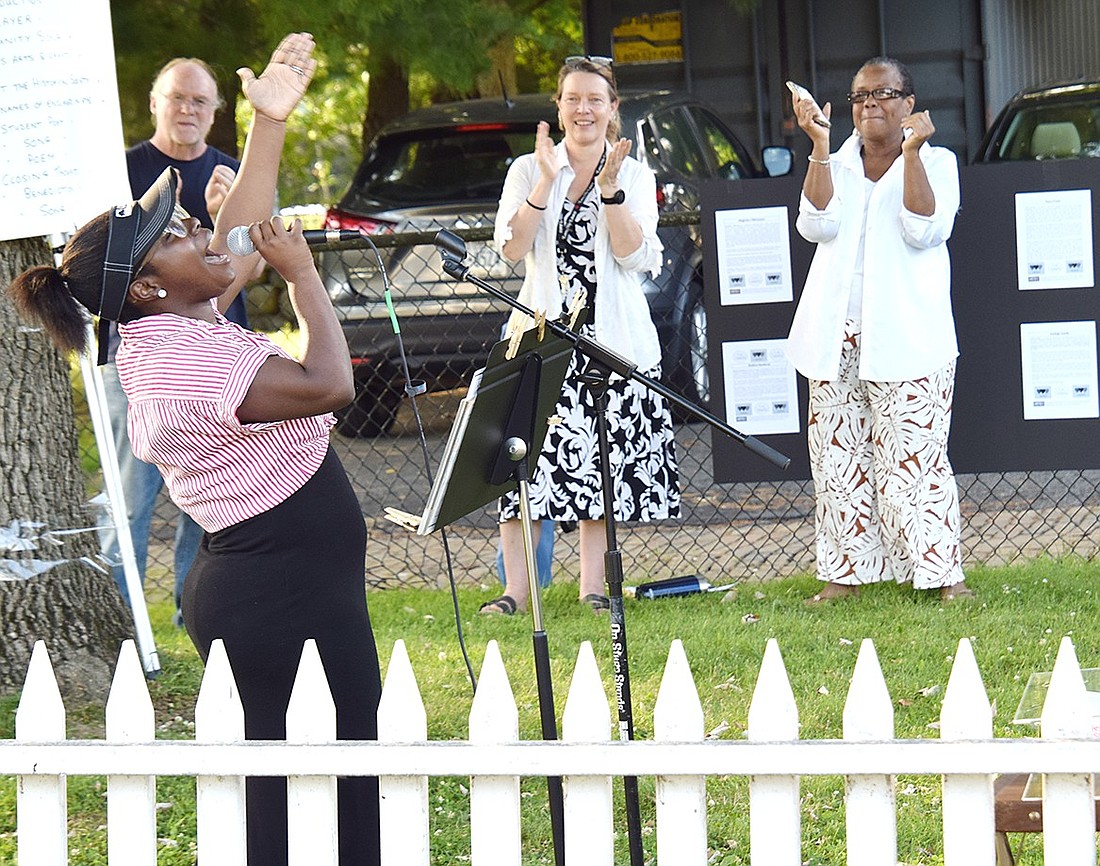 Deonna Page, a singer visiting the Port Chester Historical Society’s annual Juneteenth celebration on Wednesday, June 19, puts on a soulful performance of “Freedom” by Eddie James to get everyone on their feet. Port Chester Trustee Joan Grangenois-Thomas (right) and historical society member Kikki Short clap and dance behind her.