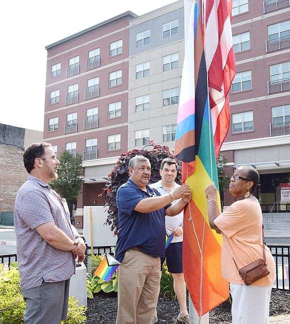 Port Chester Board of Trustees members Phil Dorazio (left), Mayor Luis Marino, John Allen and Joan Grangenois-Thomas partake in raising the Pride flag in Liberty Square on Saturday, June 22. The annual event featured live music, crafts and speeches from community leaders on the importance of inclusivity.