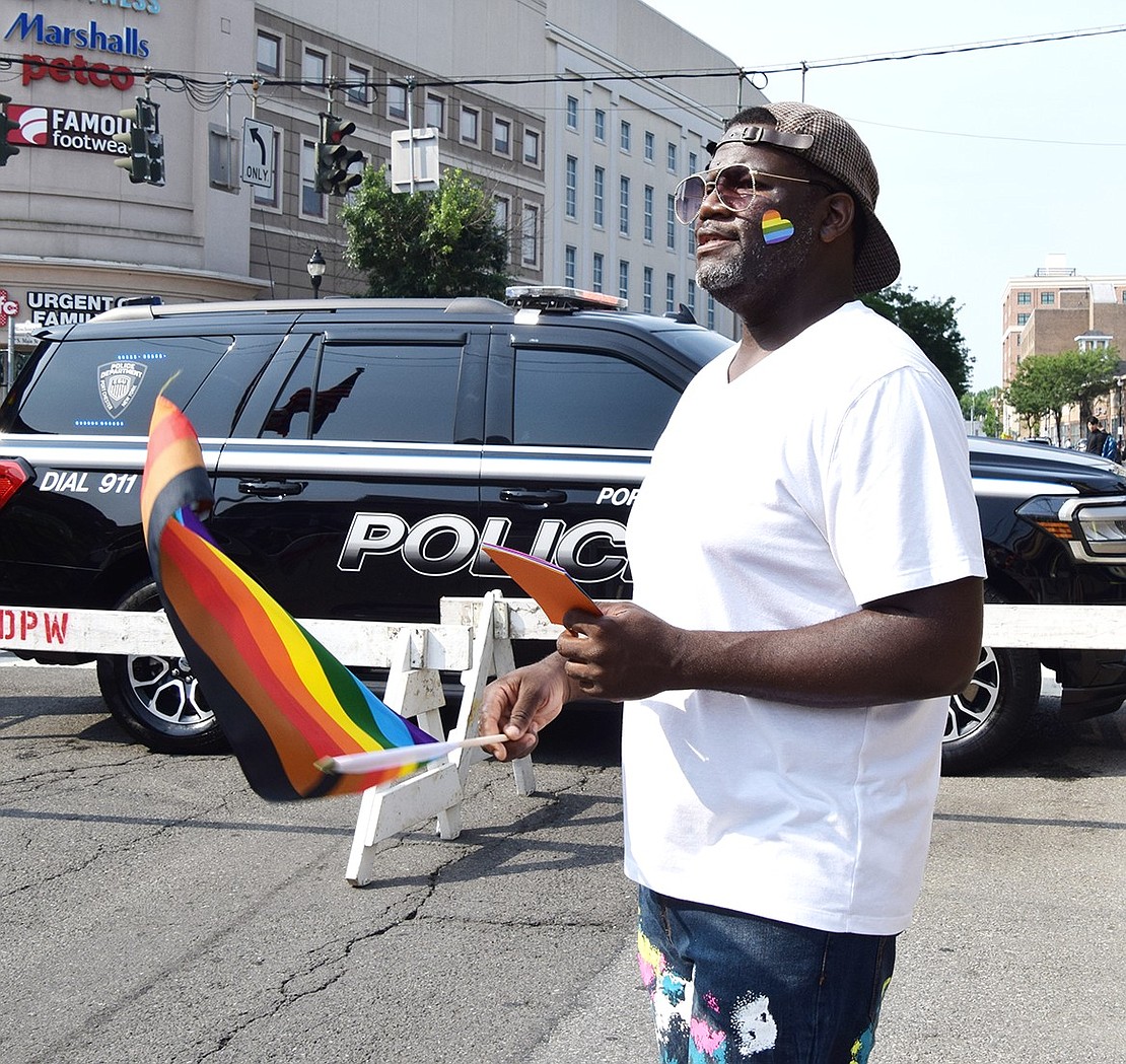 Mike Williams, a Westchester Avenue resident who assisted in creating the event, waves his Pride flag along with the music.