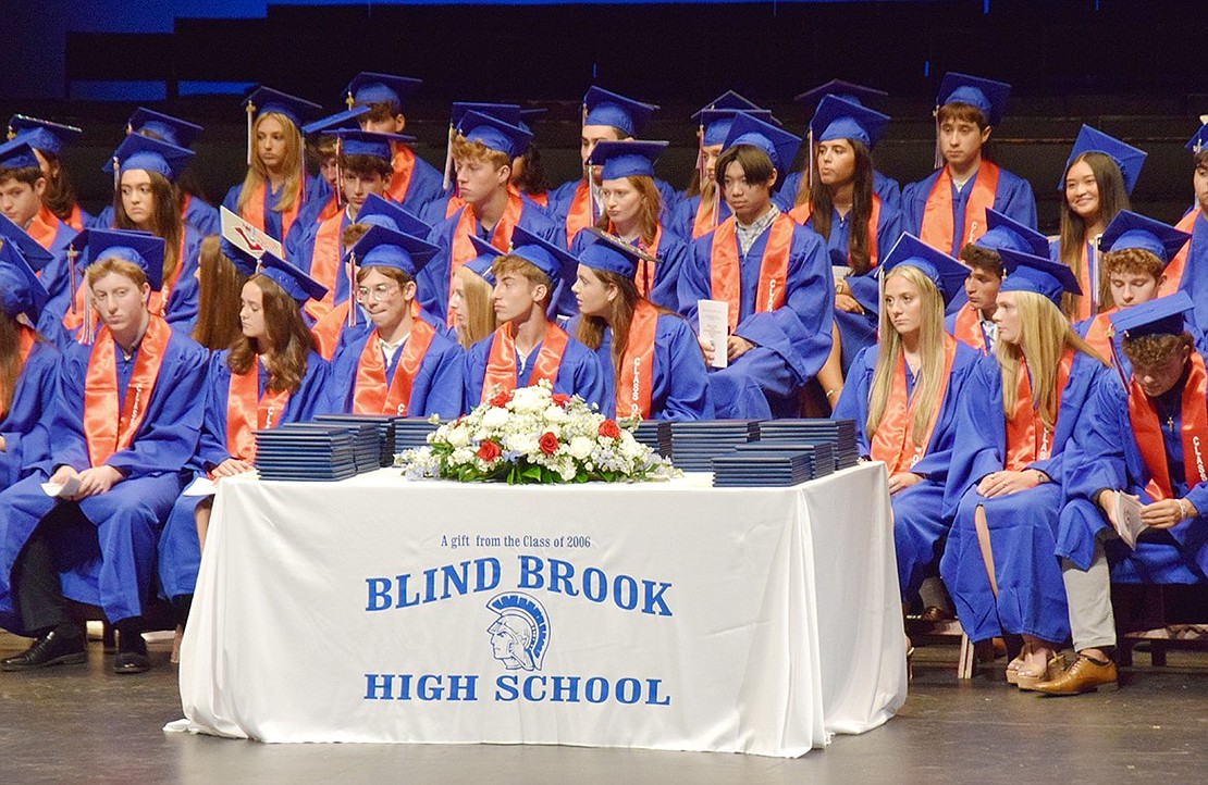 Diplomas wait for the Class of 2024 as they patiently listen to graduation ceremony speakers.